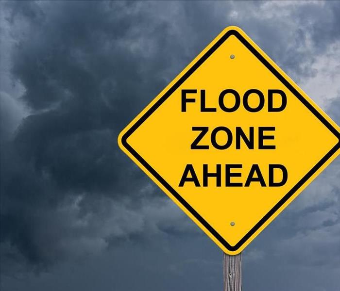 yellow flood zone sign in water