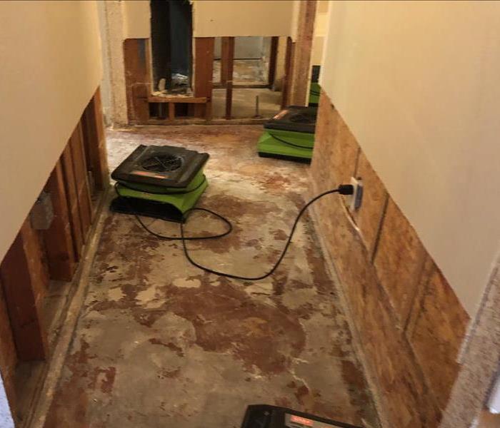 flood cuts on walls, no carpet on floor, drying equipment